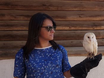Portrait of young man feeding bird