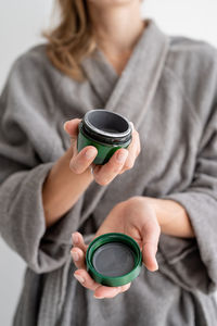 Womens health. spa and wellness. young smiling woman holding jar with clay face mask