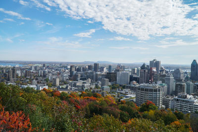 View of cityscape against cloudy sky