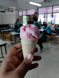 Close-up of hand holding ice cream cone