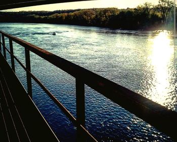 Scenic view of river against sky at sunset