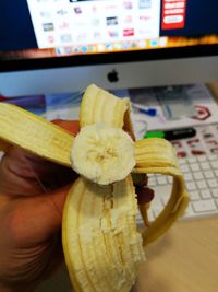 Close-up of hand holding fruit on table