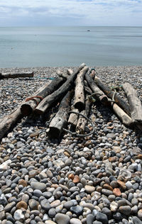 Pebbles on beach against sky