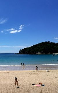 Scenic view of beach against blue sky