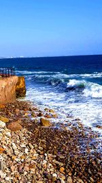 Scenic view of sea against clear blue sky