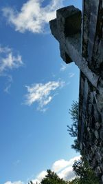 Low angle view of trees against blue sky