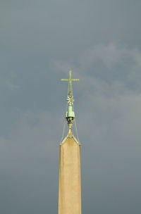 Low angle view of cross against sky