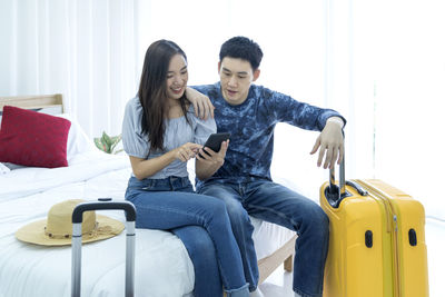 Full length of young man using mobile phone