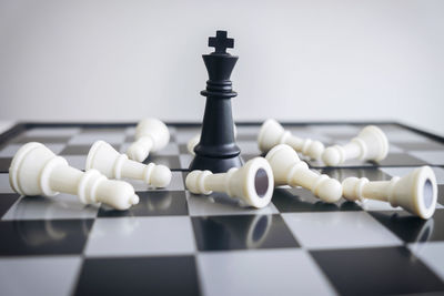 Close-up of chess pieces on board at home