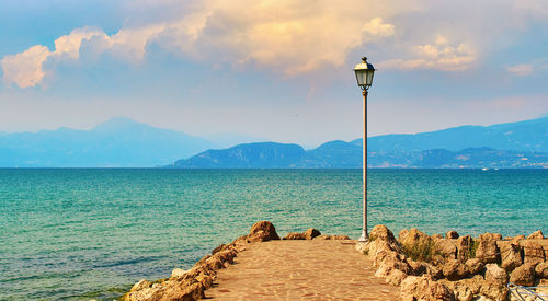 Street by sea against sky