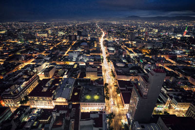 High angle view of city lit up at night