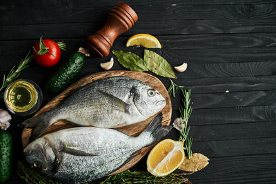 High angle view of fish and fruits on table