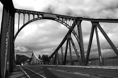 View of suspension bridge against cloudy sky