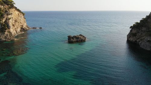 High angle view of rocks in sea against sky