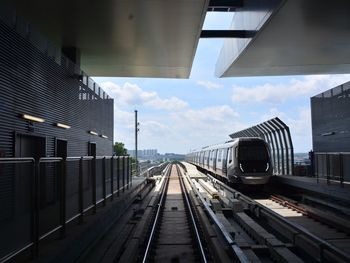 Train on railroad tracks against sky