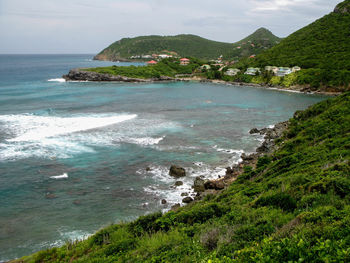 Scenic view of sea and mountains against sky