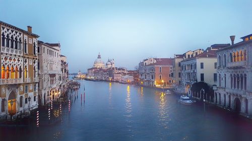 Grand canal amidst buildings in city at dusk