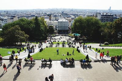 High angle view of people in park with city in background