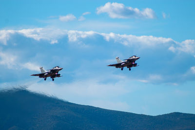 Low angle view of airplane flying against sky