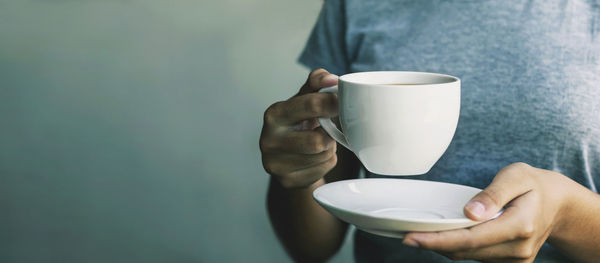 Hand holding coffee cup