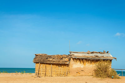 View of beach against clear blue sky