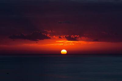 Scenic view of sea against orange sky