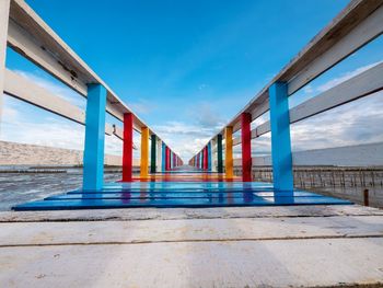 Rainbow bridge and seaside bridge, bright colors, eye-catching contrast with the clear blue sky 