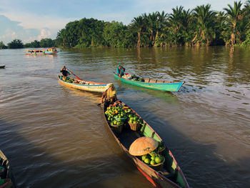 People in river against sky