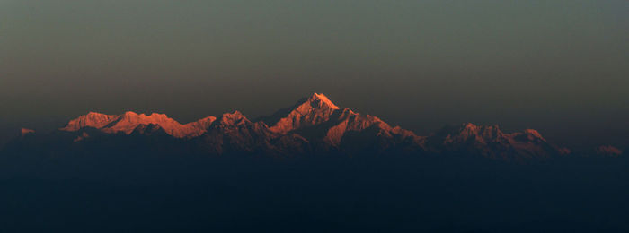 Scenic view of snowcapped mountains against sky during sunset