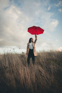 Woman standing on field against sky