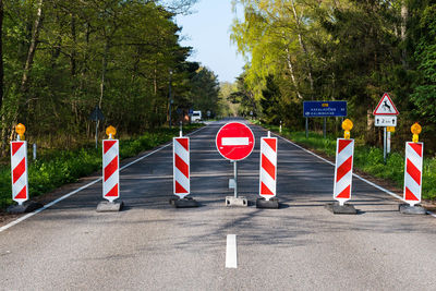 Road signs against trees in city