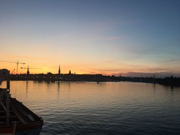 Scenic view of river against sky during sunset