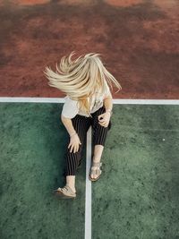 High angle view of woman standing on seat