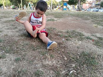 Boy sitting on grass