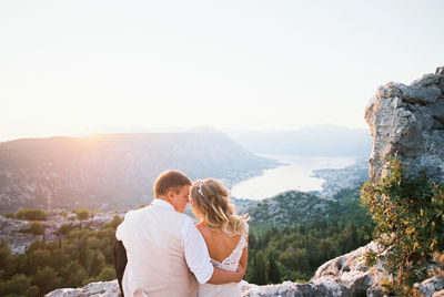 Side view of woman looking at mountains