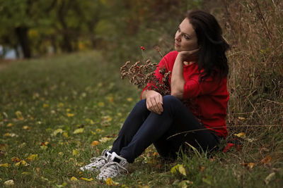 Young woman sitting on field