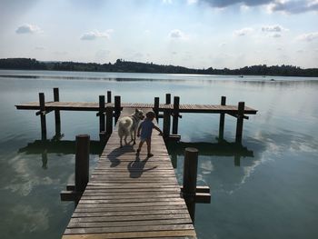 Pier over lake against sky