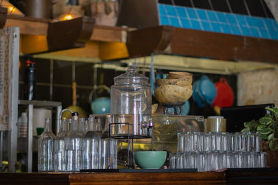 Bottles and glasses arranged on kitchen island in restaurant