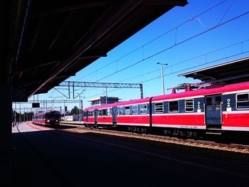 Train at railroad station against clear sky