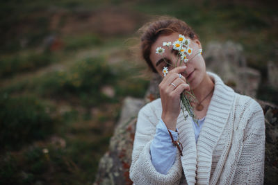 Close-up portrait of a young woman holding ice cream