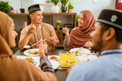 Happy family eating food at home