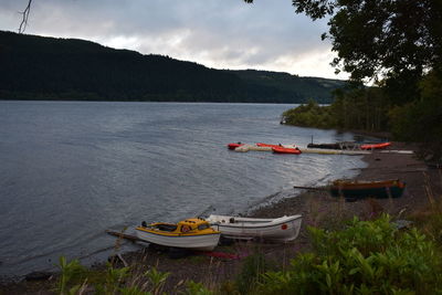 Boats in river against sky