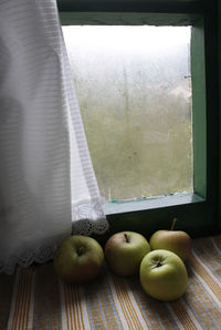 Close-up of apples on window at home