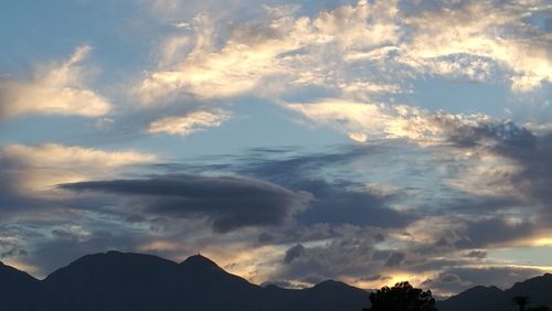 Low angle view of silhouette mountains against sky