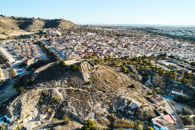 High angle view of townscape by sea against sky