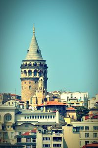 Low angle view of buildings against clear blue sky