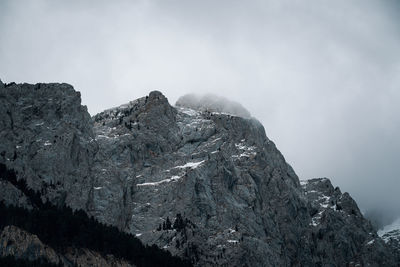 Rock formations on mountain against sky