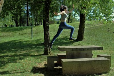 Girl jumping on picnic table