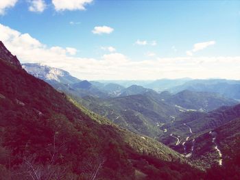 Scenic view of mountains against cloudy sky