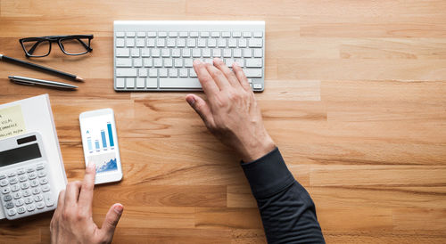 High angle view of man using laptop on table